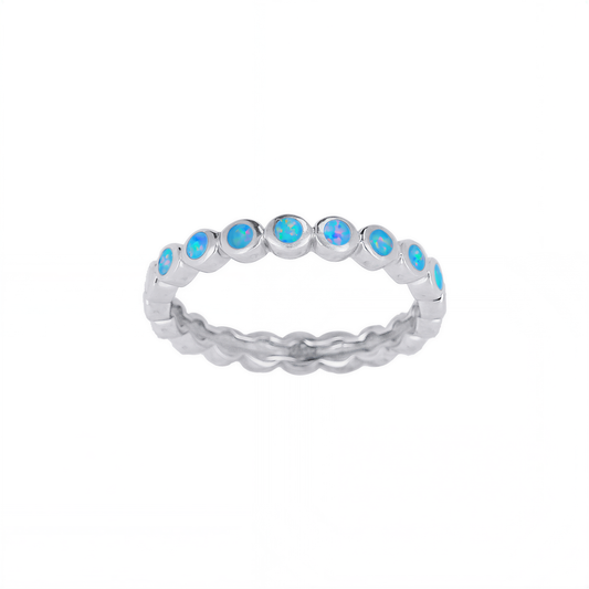 A silver ring with blue opals set in a row.